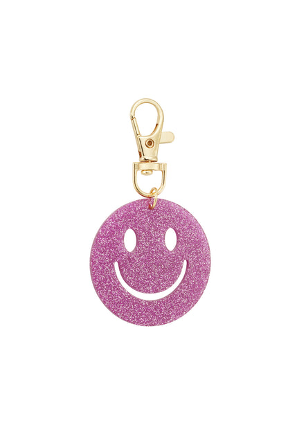 Dark purple glitter smiley face keychain against white background