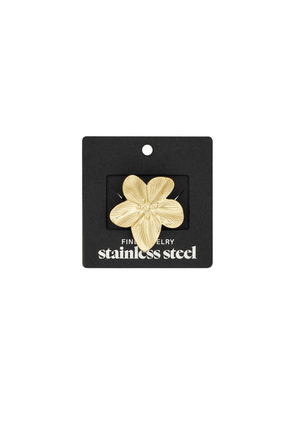 Gold flower statement ring displayed attached to black jewellery packaging labelled stainless steel