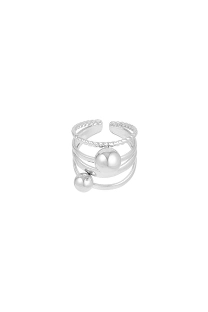 Silver version of layered ring with two spheres shown on white background