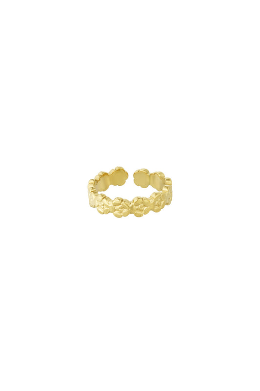 Close-up image of a gold open band ring featuring a delicate embossed floral pattern on a white background