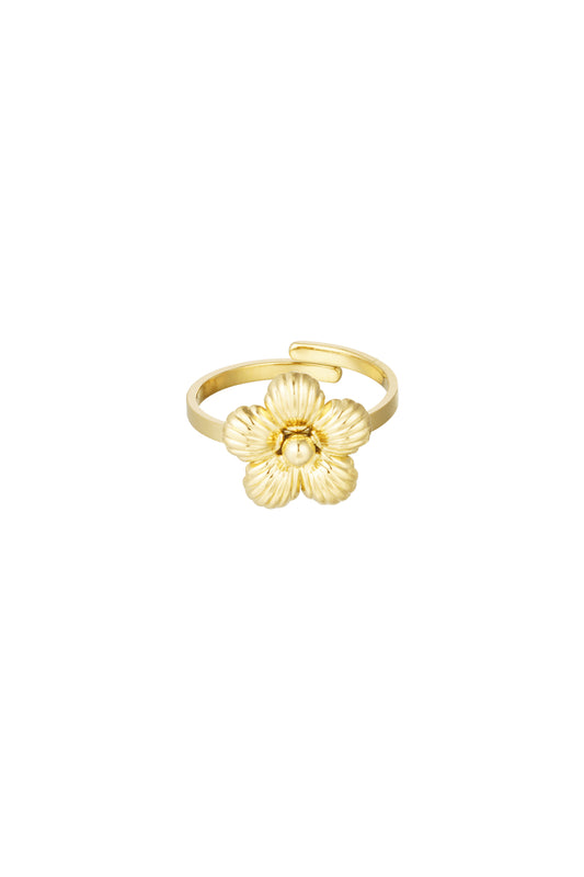 Gold statement ring with detailed floral design on a white background