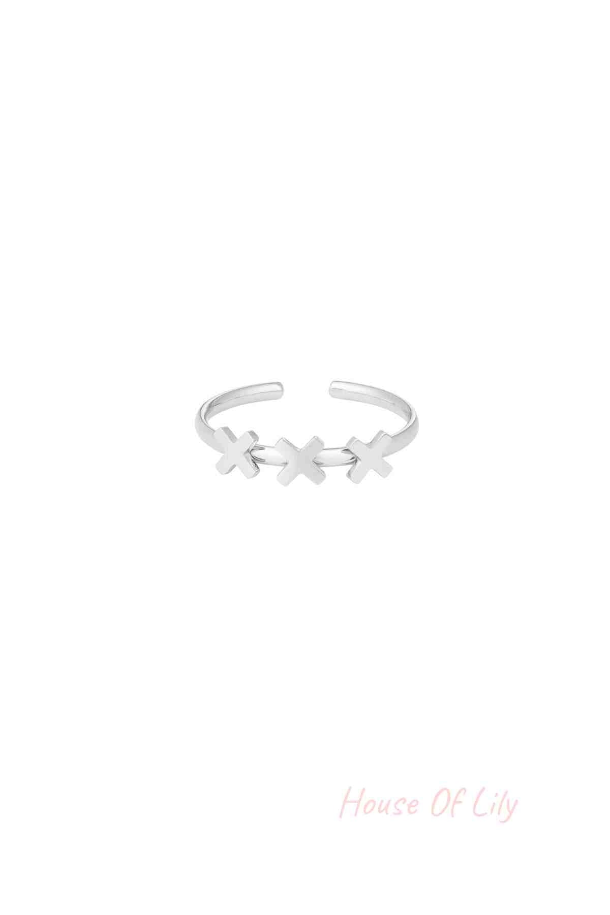 Silver-tone adjustable ring with three cross shapes on a white background