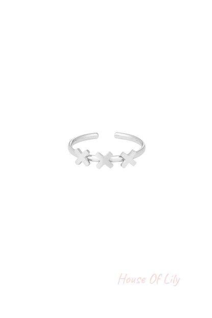 Silver-tone adjustable ring with three cross shapes on a white background