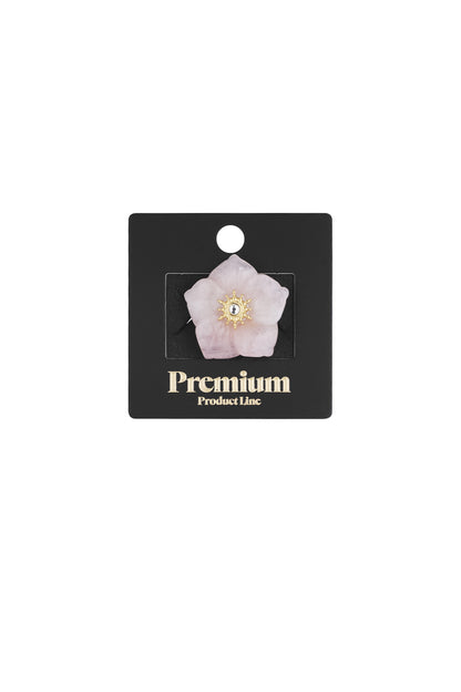 Pink floral statement ring displayed on black Premium Product Line card