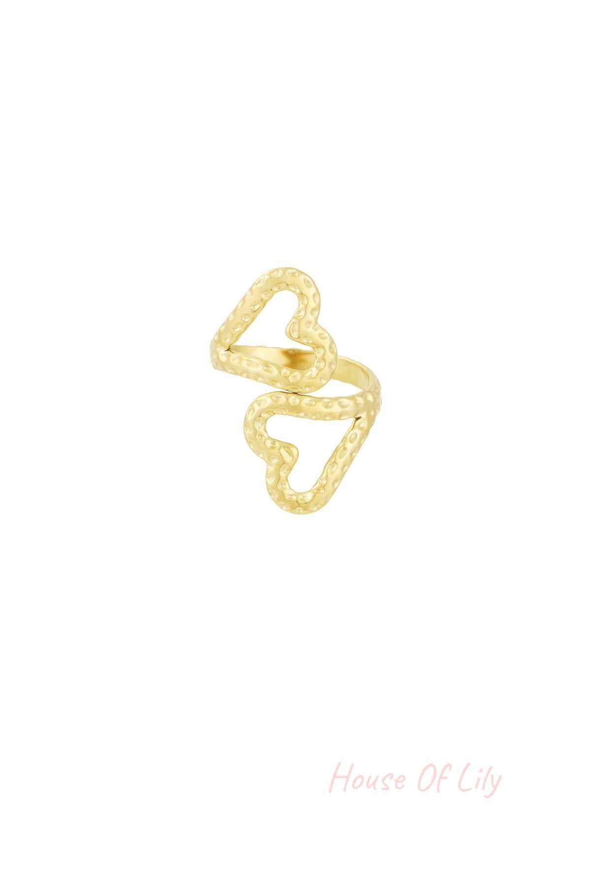 Gold-toned textured open heart ring set against a white background