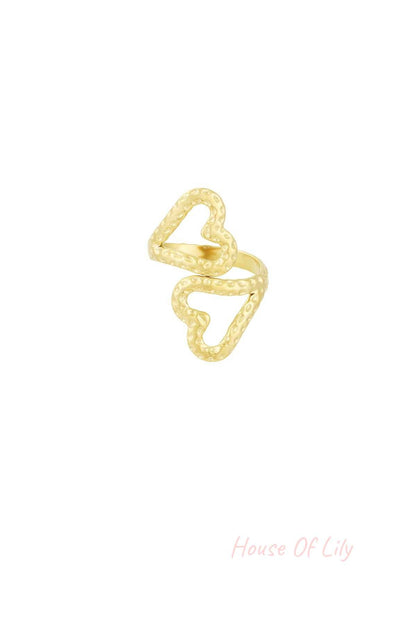 Gold-toned textured open heart ring set against a white background