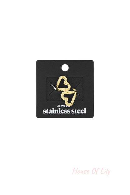 Gold textured open heart ring displayed on black packaging card labeled stainless steel