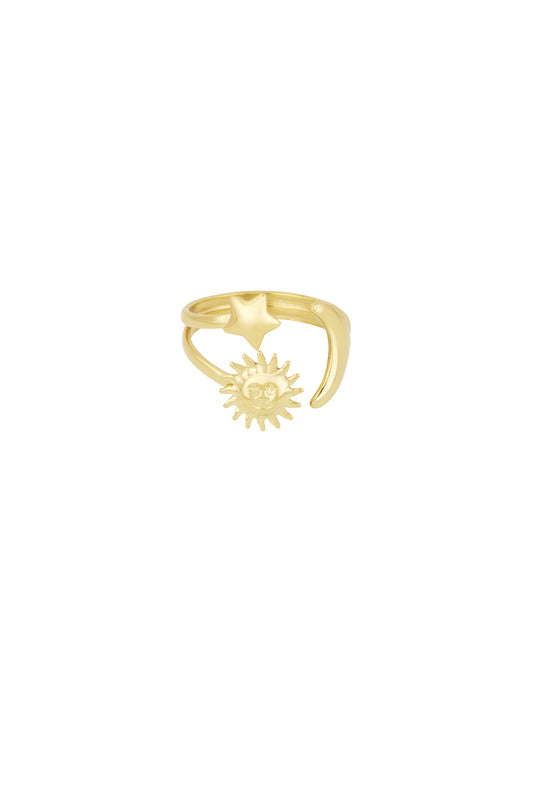 Gold celestial statement ring with star, crescent moon, and sun motifs on a white background