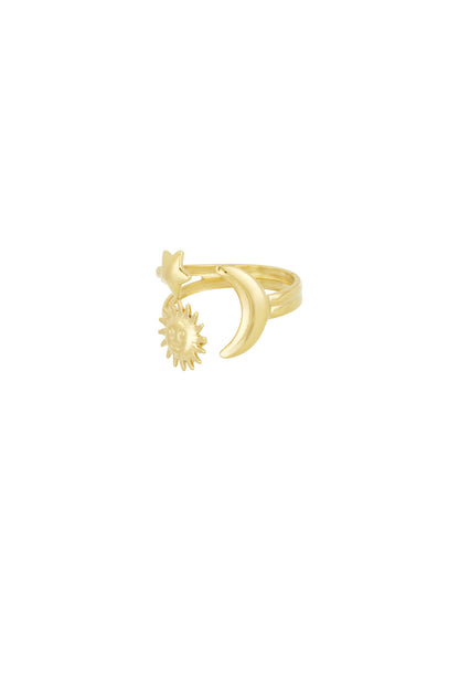 Angled side view of gold celestial star, moon, and sun ring on white background