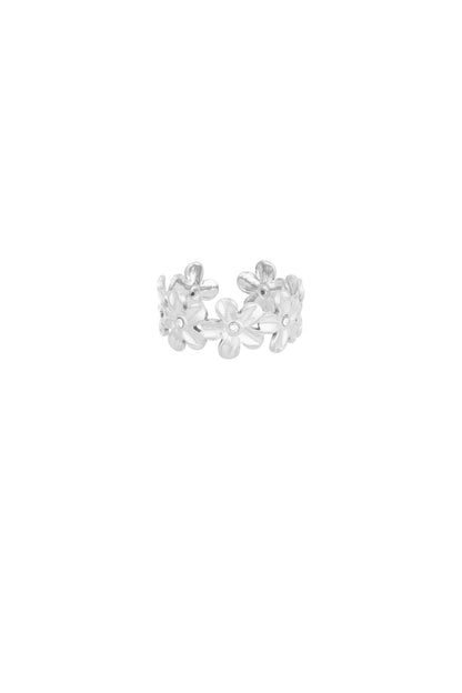 Silver daisy flower statement ring with crystal centres on white background, angled view