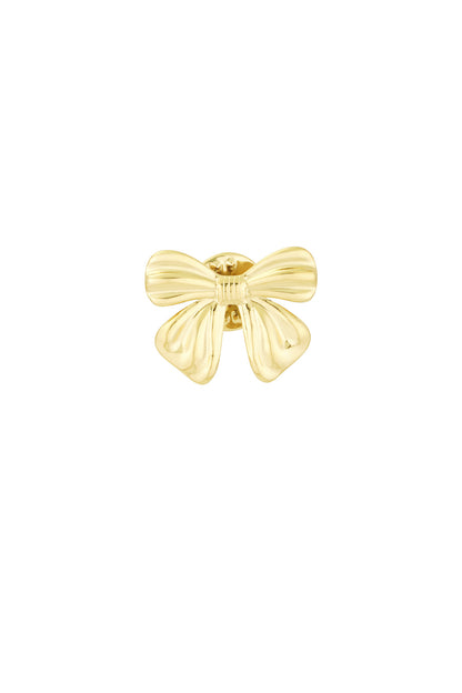 Close-up of polished gold bow-shaped brooch with smooth curves on white background
