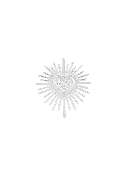 Silver tone brooch with radiant sunburst pattern and stone-studded heart centerpiece isolated on white background