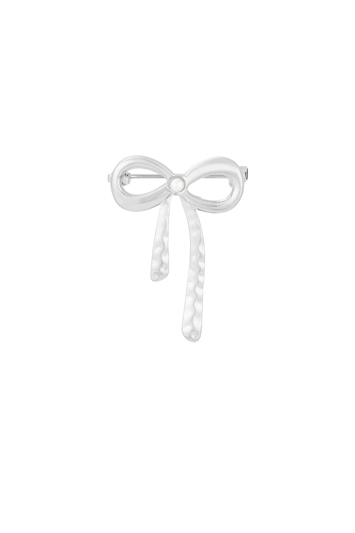 Silver hammered bow brooch with pearl center on white background