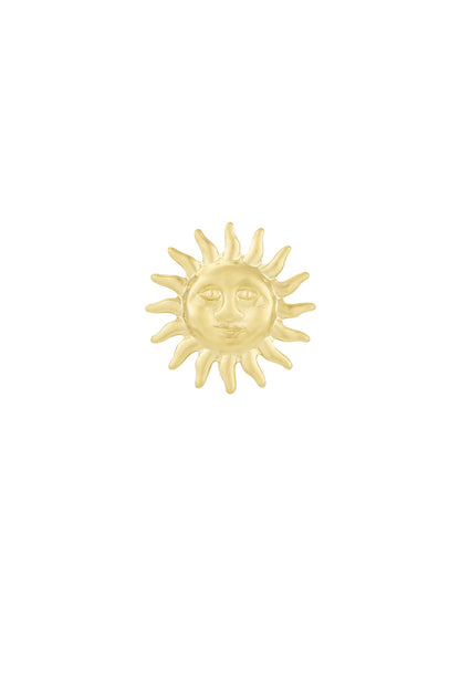 Close-up of a gold-toned metal brooch shaped like a radiant sun with a smiling face on a white background