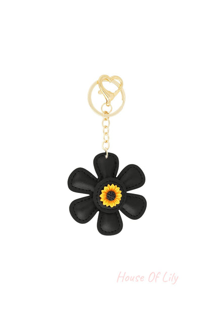 Black faux leather floral keychain with a gold heart clasp and sunflower center