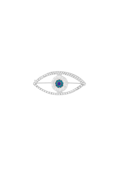 Silver-tone evil eye brooch with clear crystals outlining the eye shape and blue crystals in the center on white background