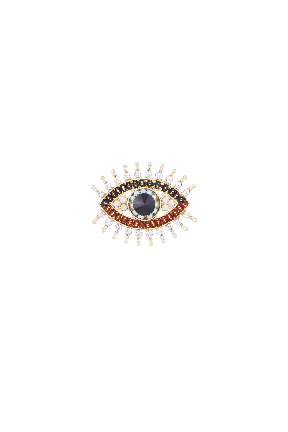 Close-up of a gold eye brooch with colorful crystal stones including black, red, white, and turquoise, arranged to mimic an eye with lashes