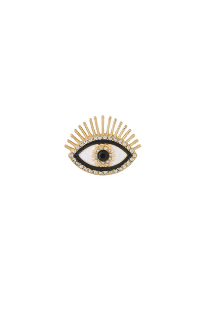 Gold-tone eye-shaped brooch with clear rhinestones and black enamel details on a white background