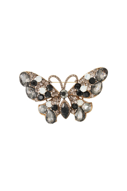 Smoky gray and black crystal butterfly brooch with white stones on a gold alloy base