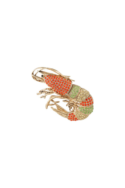 Close-up of colorful shrimp brooch with red, green, and yellow rhinestones on gold-tone alloy