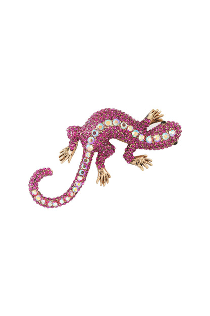 Close-up of magenta and iridescent crystal gecko brooch on white background