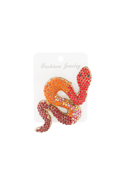 Vibrant red and orange crystal snake brooch displayed on white jewelry card