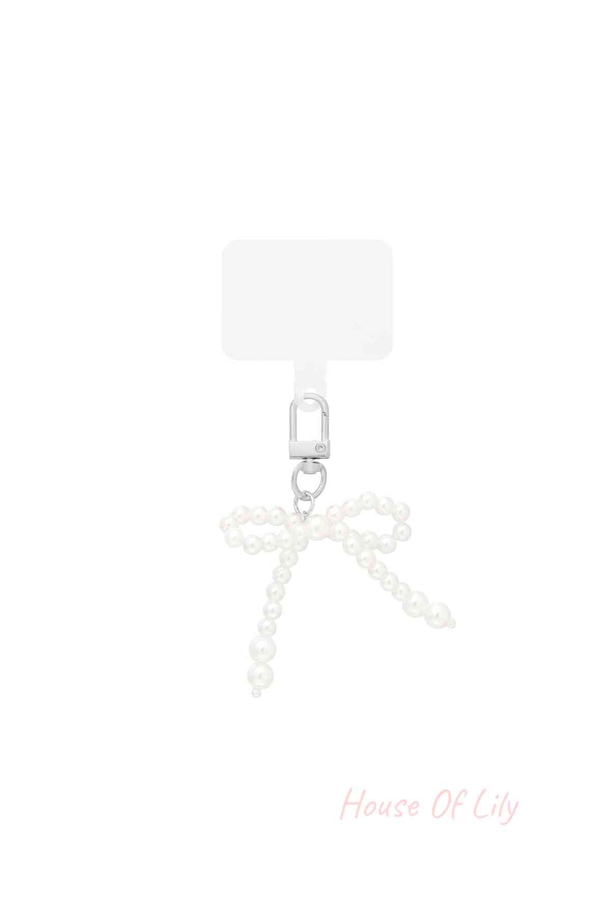 Pearl bow shaped bag charm with silver clasp on white background
