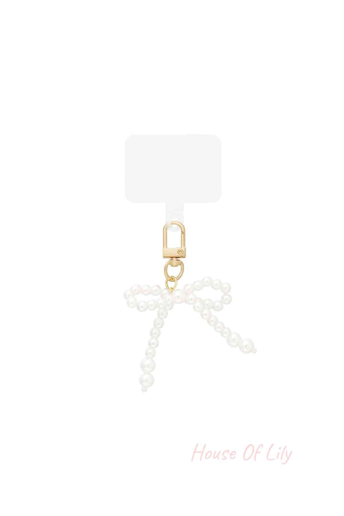 Pearl bow shaped bag charm with golden clasp on white background