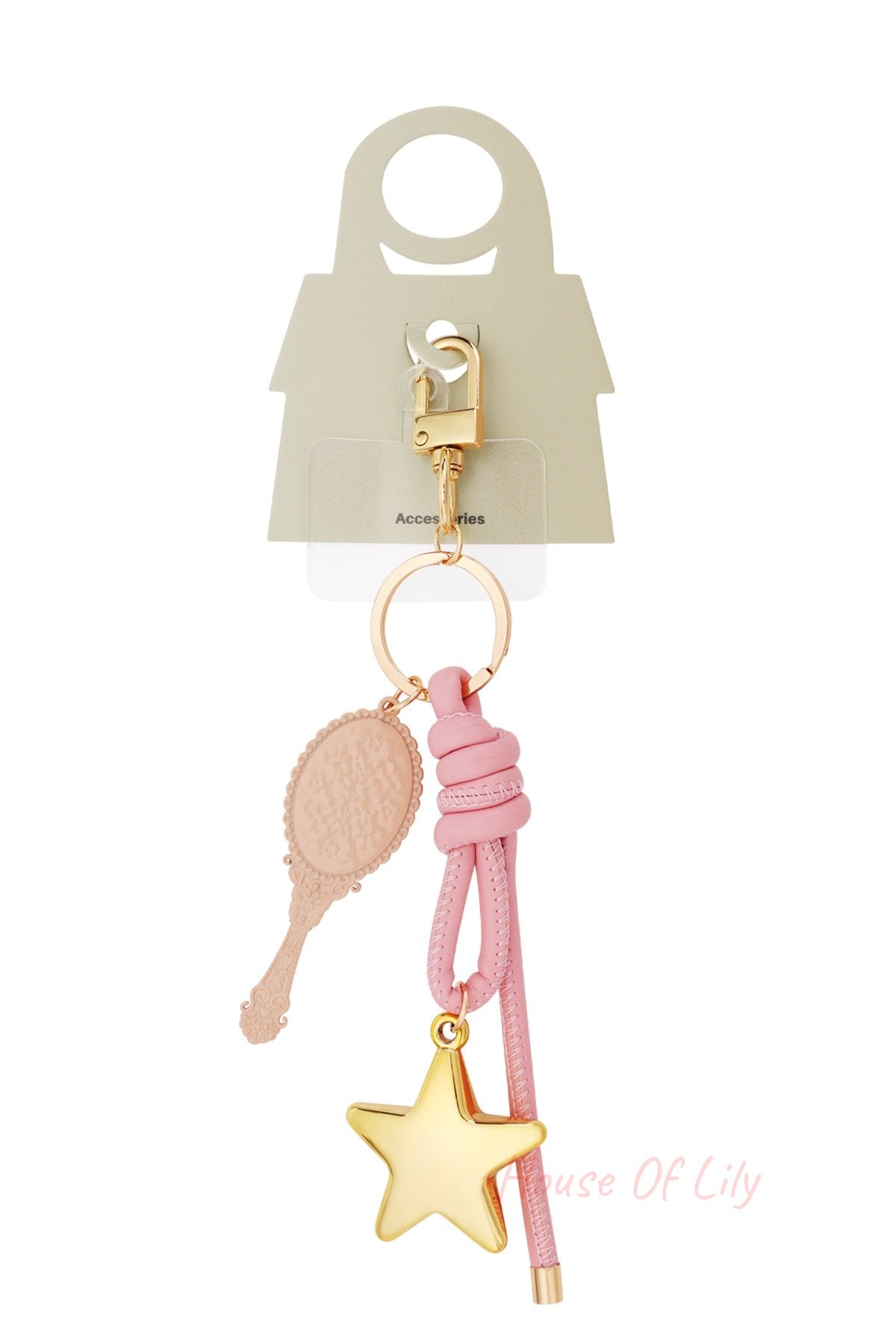 Bag charm with golden clip hook, pink knotted leather, golden star pendant and beige vintage mirror pendant shown with packaging