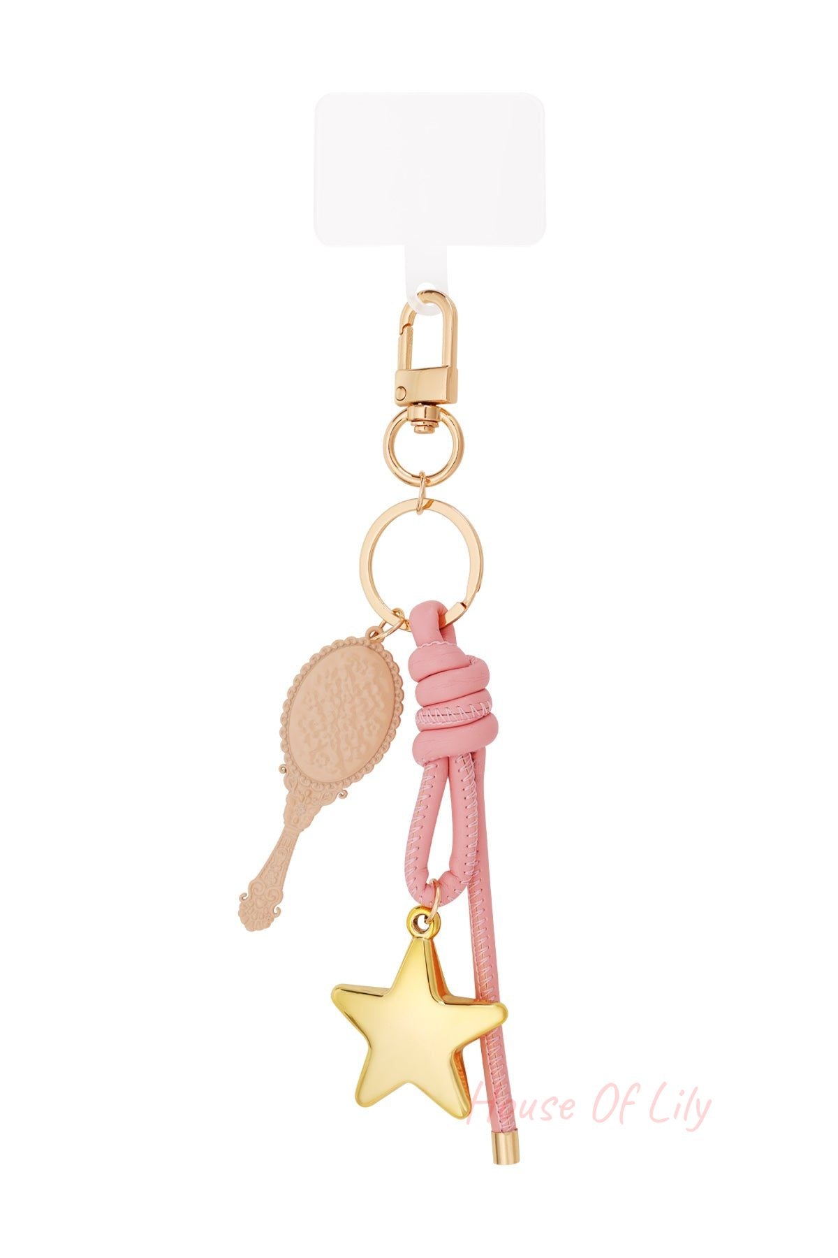 Close-up of chic bag charm with golden star pendant, pink knotted leather and vintage-style mirror pendant on white background