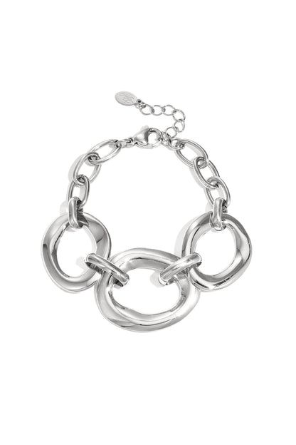 Silver chunky link bracelet with three large irregular oval links and lobster clasp on white background