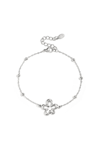 Minimalist silver floral charm bracelet with single flower charm on chain and lobster clasp on white background