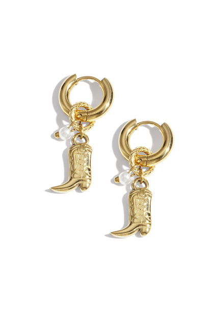 Gold hoop earrings with cowboy boot charms and pearl accents displayed on white background