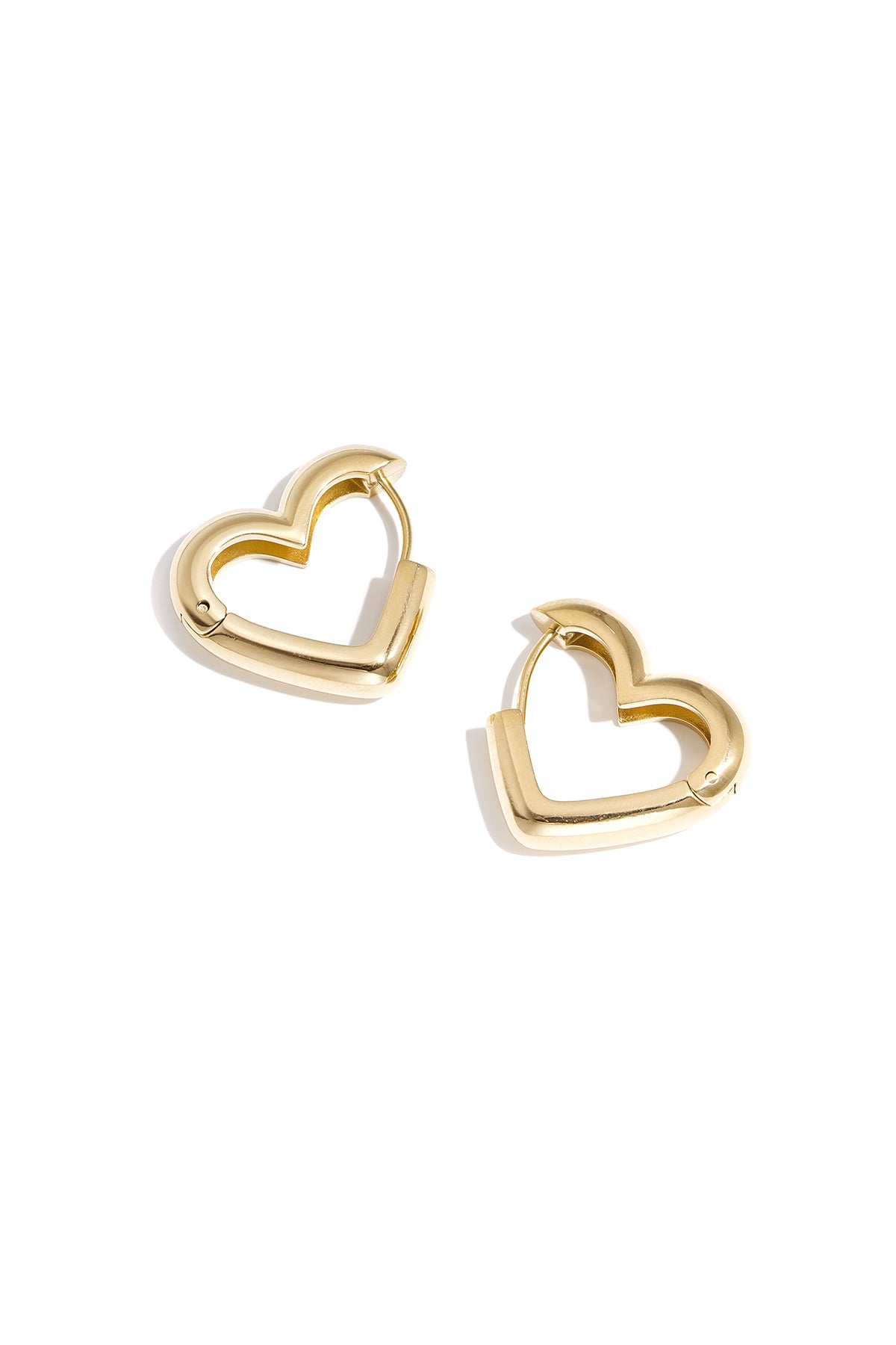 Detailed image of silver heart-shaped hoop earrings with clean white backdrop