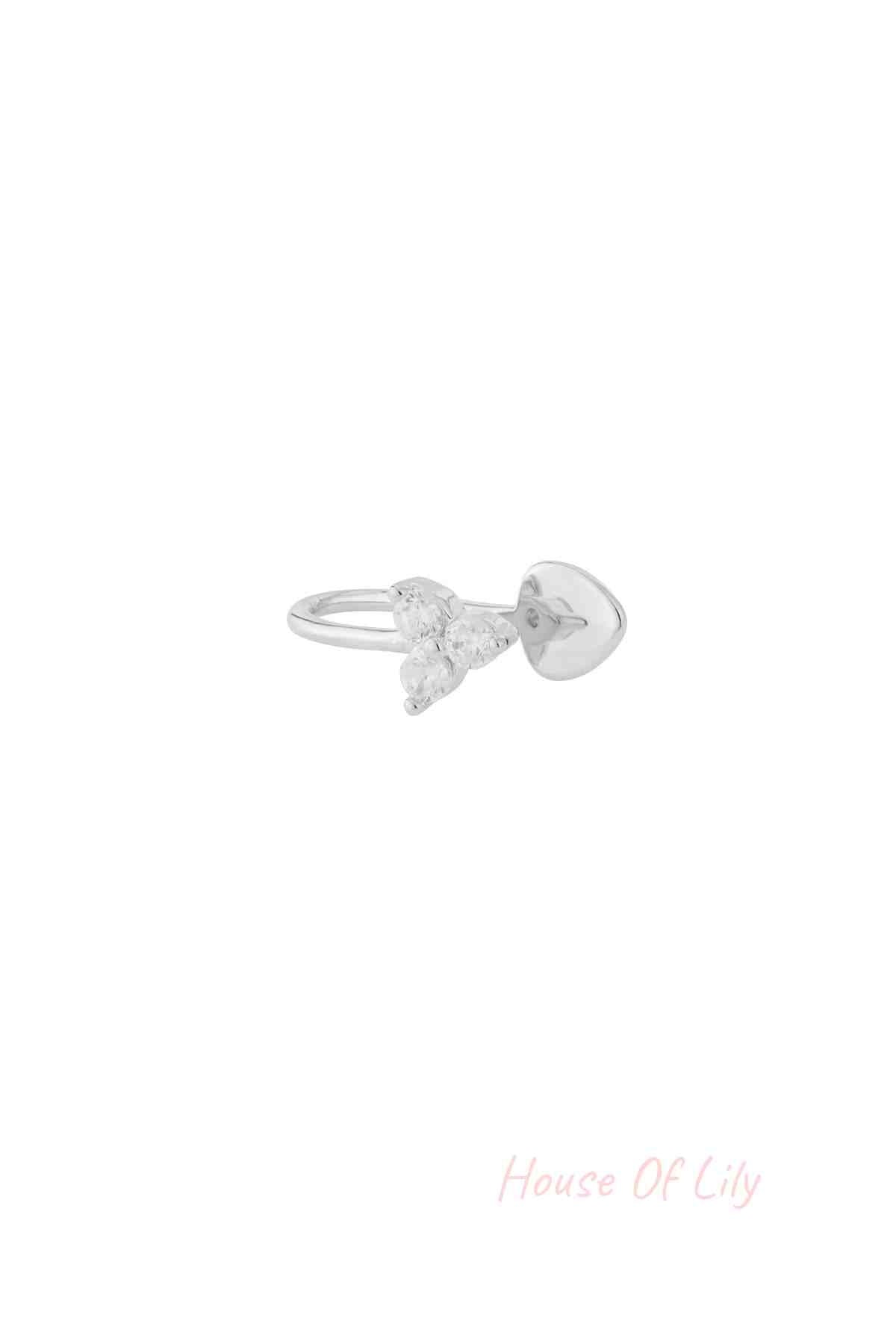 Silver nose cuff with three clear zircon stones in triangular shape isolated on white background