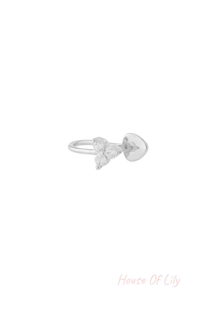 Silver nose cuff with three clear zircon stones in triangular shape isolated on white background