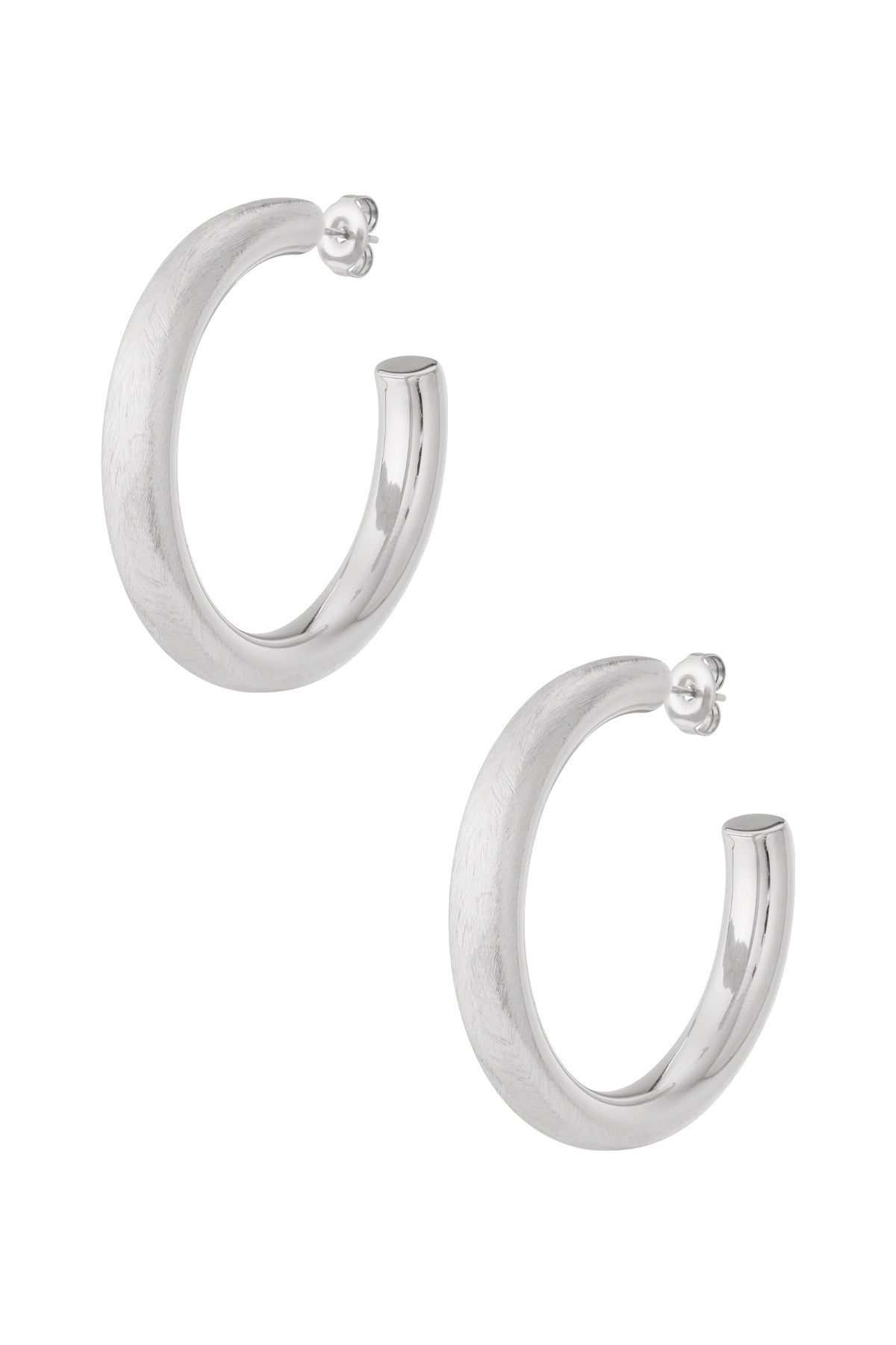 Pair of chunky silver hoop earrings with half matte and half polished finish displayed on white background