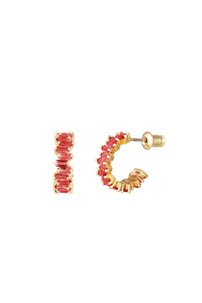 Gold-tone semi-circle hoop earrings adorned with red baguette crystals displayed on a white background