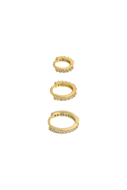 Three gold-tone hoop earrings lined with sparkling clear stones in small, medium, and large sizes on white background