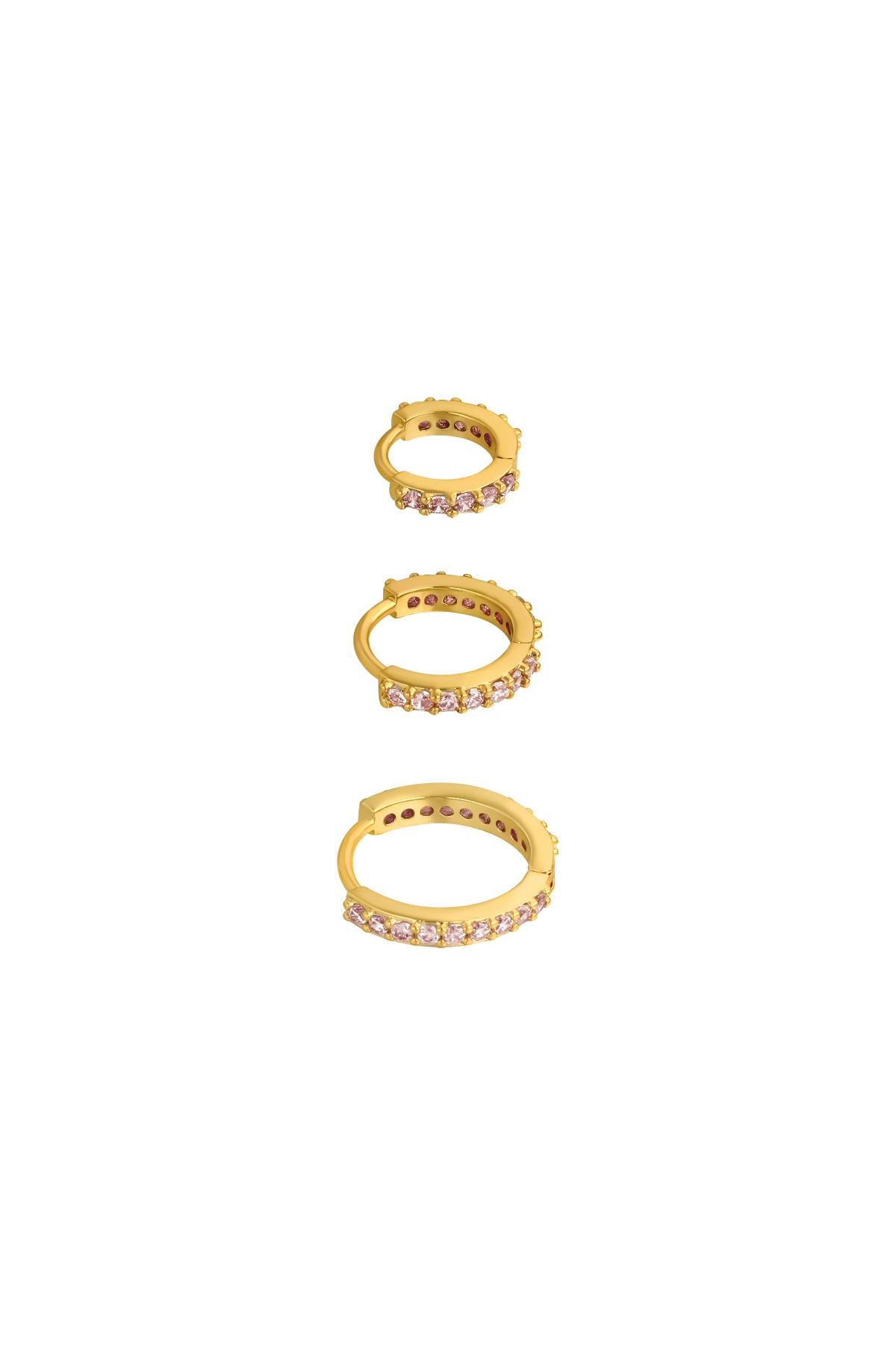 Three gold-tone hoop earrings lined with pink stones in small, medium, and large sizes on white background