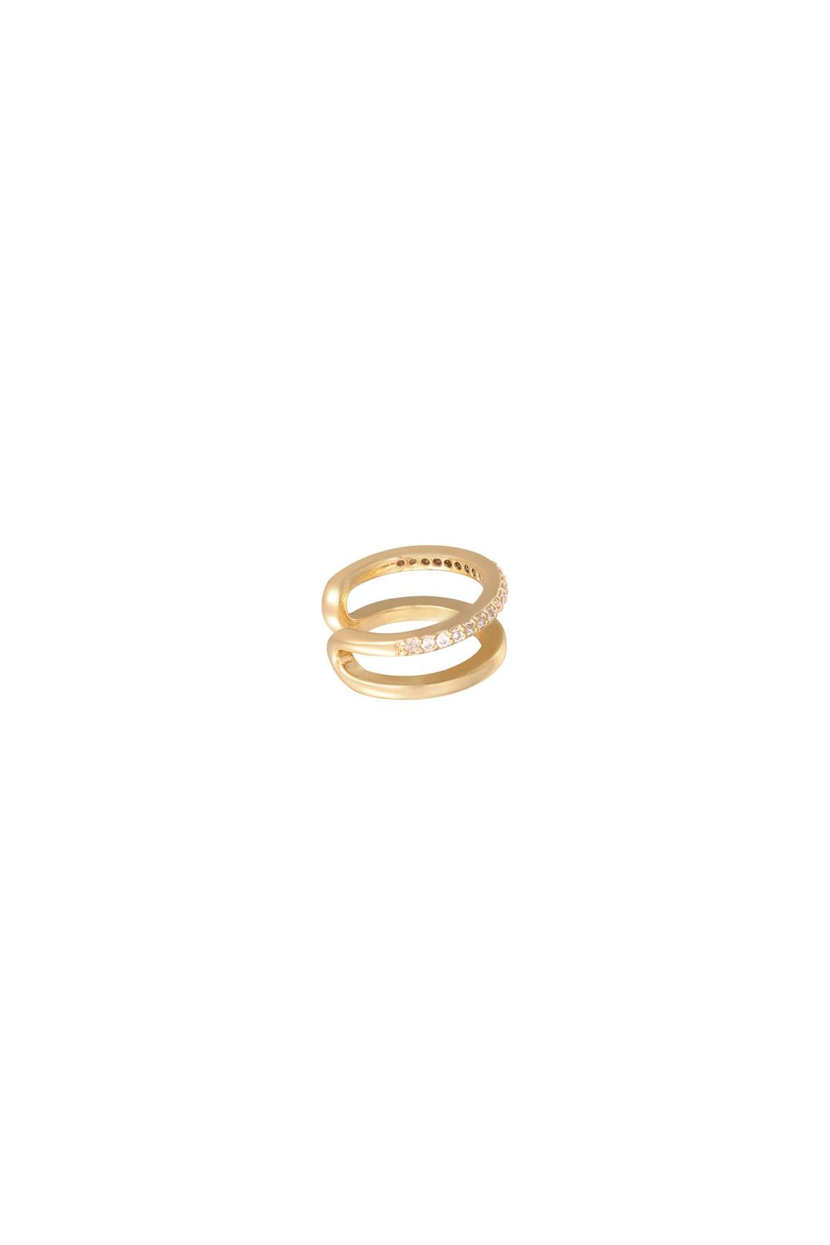 Gold double band ear cuff with one band studded with small clear crystals on a white background