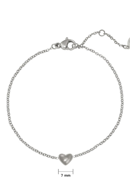 Close-up of silver chain bracelet with 7mm heart charm and lobster clasp on white background