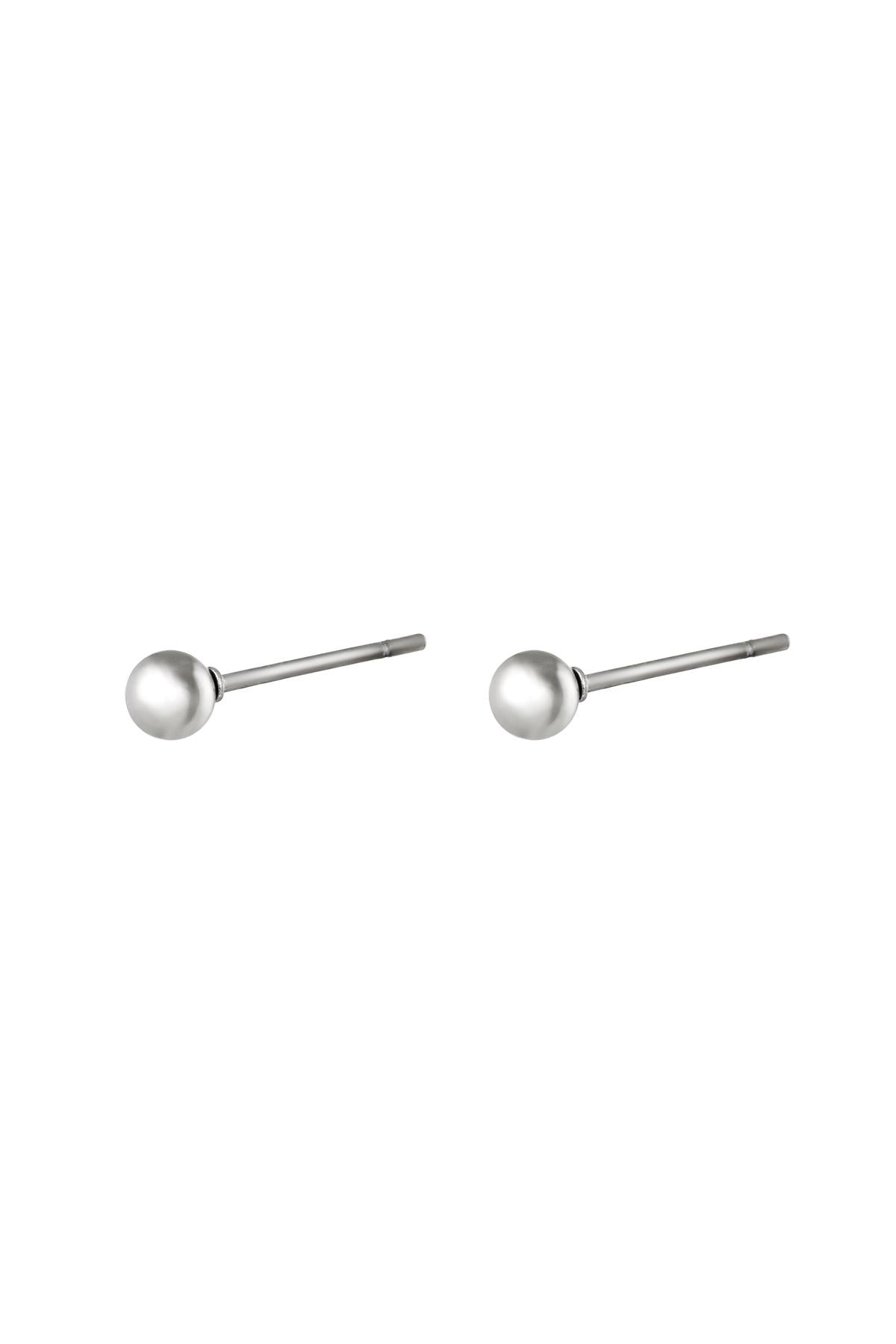 Pair of minimalist silver ball stud earrings isolated on white background