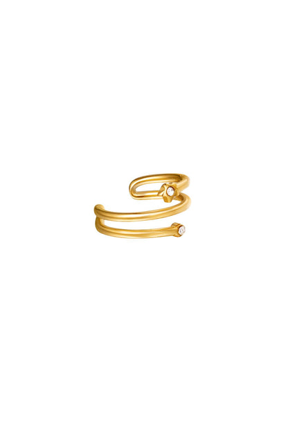 Gold spiral earcuff with small zircon stones on a white background