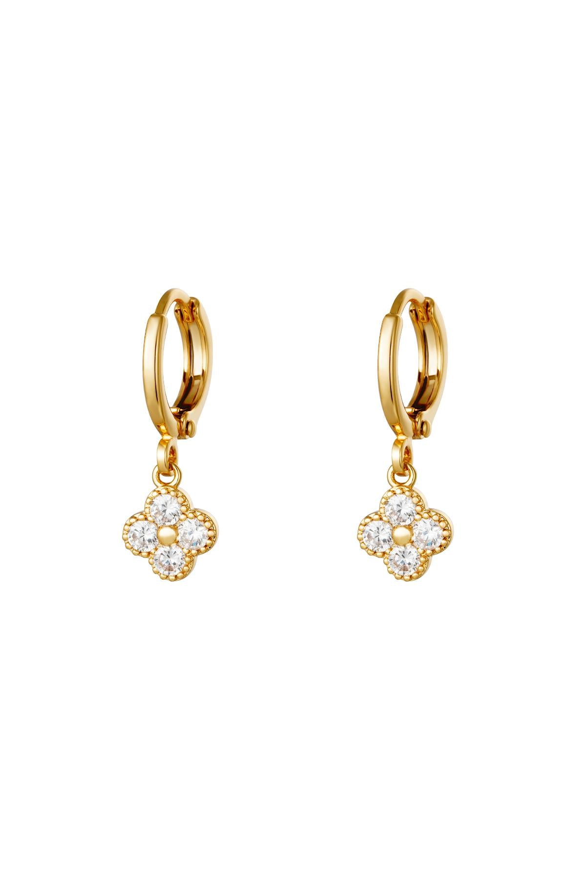 Pair of gold clover drop earrings with clear zircon crystals on a white background