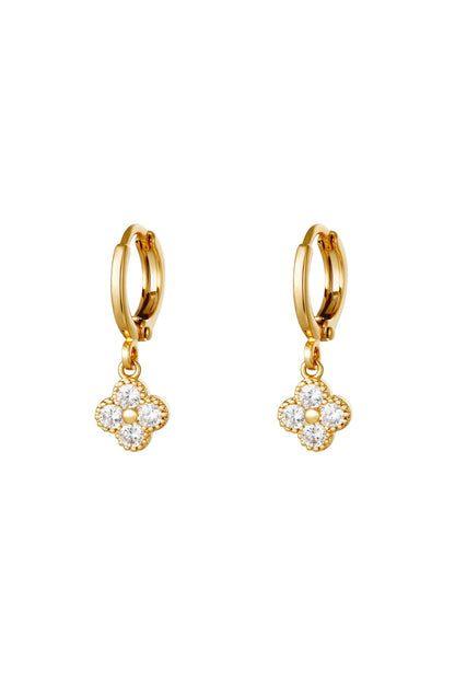 Pair of gold clover drop earrings with clear zircon crystals on a white background
