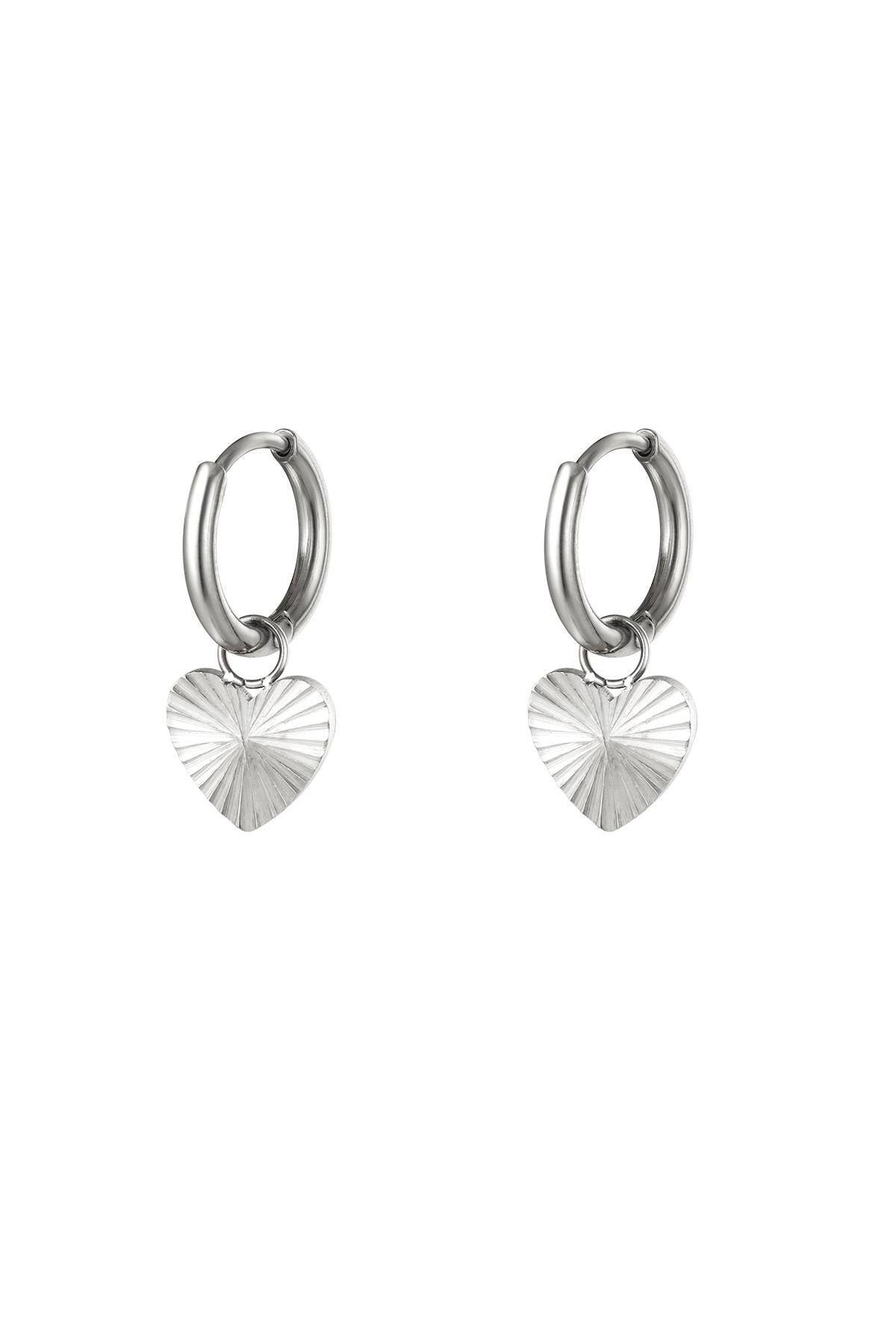 Pair of polished silver stainless steel hoop earrings with textured heart pendants