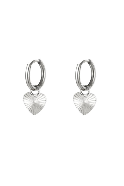 Pair of polished silver stainless steel hoop earrings with textured heart pendants