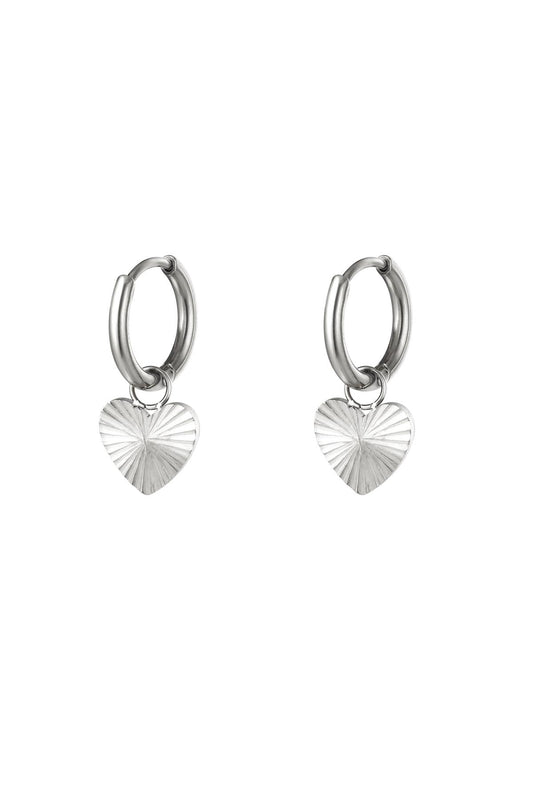 Pair of polished silver stainless steel hoop earrings with textured heart pendants
