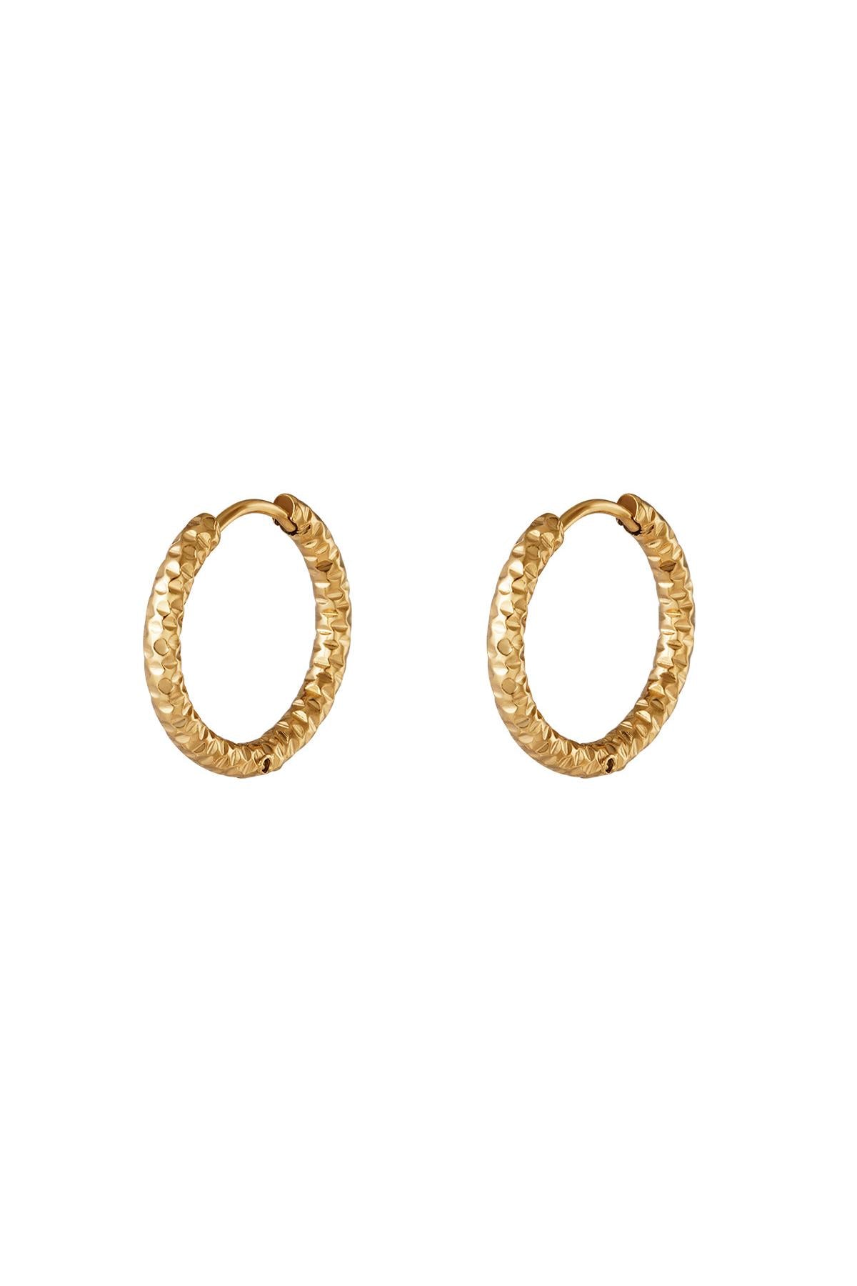 Pair of gold textured hoop earrings with hammered pattern displayed on a white background
